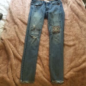 Abercrombie jeans with patches and frayed bottoms